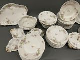 a lot of plates and bowls that are sitting on a table