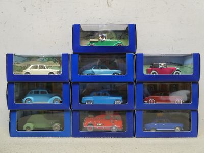 six blue boxes with cars in them on a white surface