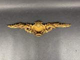 an image of a metal object with a gold decoration on top of it