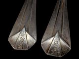 pair of silverware spoons on a black background with a black background