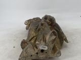 a small statue of a turtle on a white surface