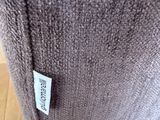 the label is on the back of a chair that is sitting on the floor