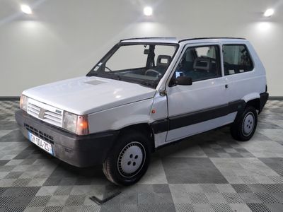 a small white van parked on a checkered floor
