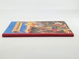 a red book sitting on top of a white table next to a white wall