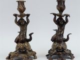 pair of bronze figurines of a boy and a girl on a rock