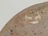 a stone with a tag on it sitting on a table