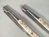 two pens that are sitting on a white surface