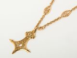 an image of a gold necklace with a cross on it