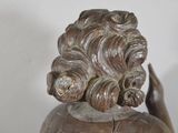 a statue of a woman with a flower in her hair