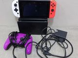 a nintendo wii game console with two controllers and a charger