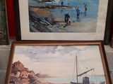 two framed pictures of a boat on the beach