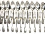 a lot of silver spoons and forks on the table