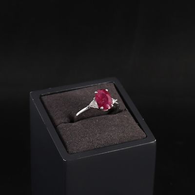 ruby and diamond ring in a black box on a black background
