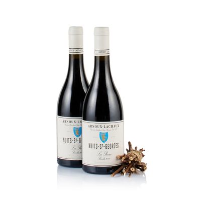 two bottles of wine sitting next to each other on a white surface