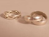 pair of silver rings sitting on top of each other on a table