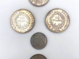 four different types of coins sitting on top of a white surface