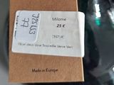 a small glass vase with a tag attached to it