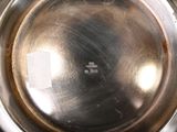 a close up of a metal bowl with a label on it