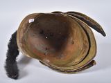 an old helmet with a feather on top of it