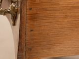 a close up of a wooden drawer with a clock on it