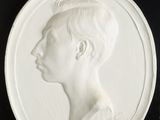 a close up of a white plate with a woman ' s profile on it