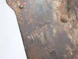 a rusted piece of metal on a white surface