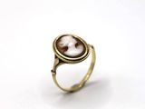 an image of a gold ring with a picture of a woman ' s face on it