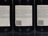 three bottles of wine sitting on top of a table next to each other