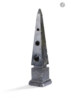 une sculpture représentant un objet de forme triangulaire posé sur une surface blanche