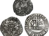 trois pièces d'argent, dont l'une est ornée d'une croix et l'autre d'un lion