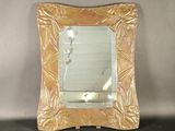 a mirror that is sitting on a table in a room