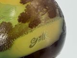a yellow and green vase with a tree design on it