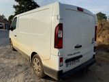 a white van parked on the side of a dirt road