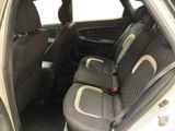 the back seats of a white car with a black seat belt