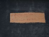 a close up of a piece of wood with writing on it