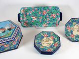 trois petites boîtes ornées de motifs, posées sur une surface blanche