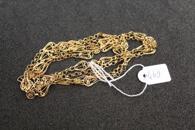 a close up of a gold chain with a price tag on it