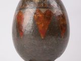 a vase that is sitting on top of a wooden stand