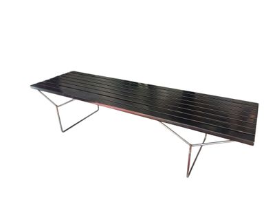 a black bench that is sitting on a white surface