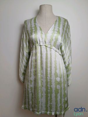the dress is green and white with stripes on it
