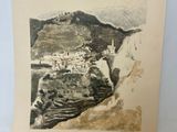 an old picture of a mountain with a town on it