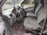 the interior of a van with the front seats down and a steering wheel in the center