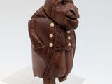 an image of a small statue of a man in a coat