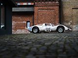 a white and blue race car parked in front of a brick building
