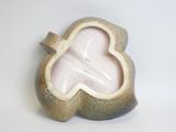 a small vase that has a heart shaped design on it