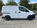 a white van parked in a parking lot with trees in the background