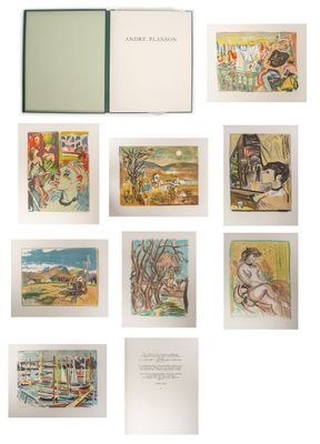an open book sitting on top of a white table next to a bunch of pictures