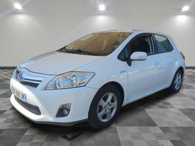 a picture of a white toyota prius parked on a checkered floor