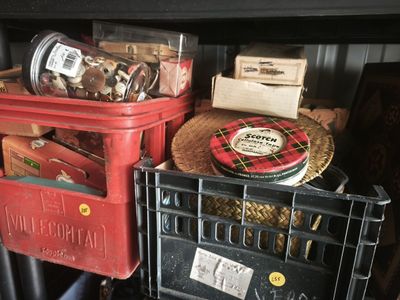 many different types of items in the bins on the shelf