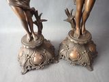 two bronze statues of a woman and a man